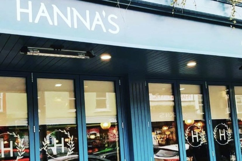 The blue Hanna's shopfront on Patrick Street, Fermoy, with outdoor tables